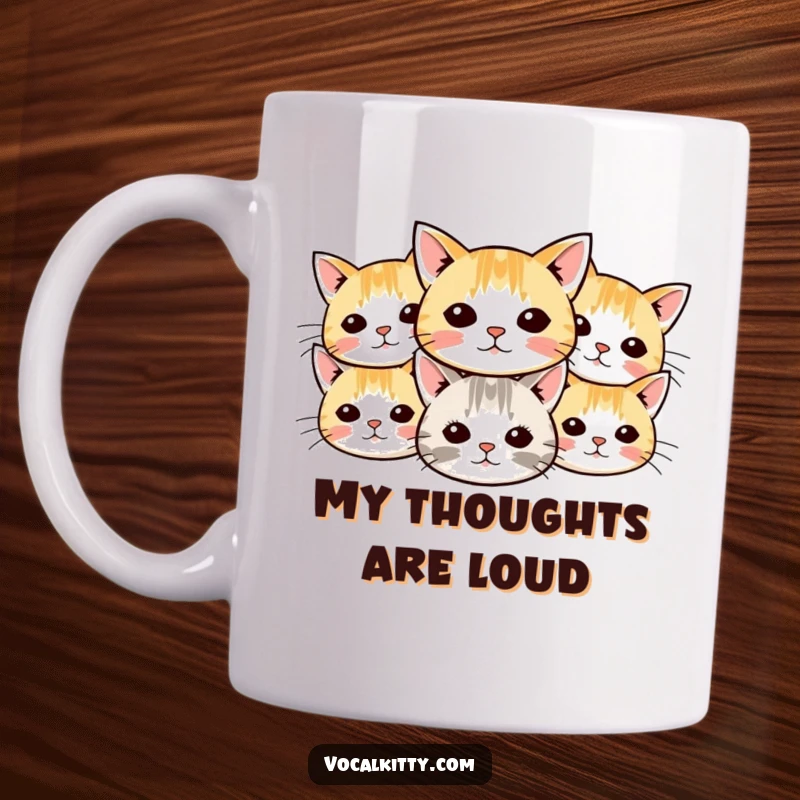 Funny cat mug displaying multiple small cartoon cat heads with whiskers radiating outwards in a cheerful, symmetrical pattern.