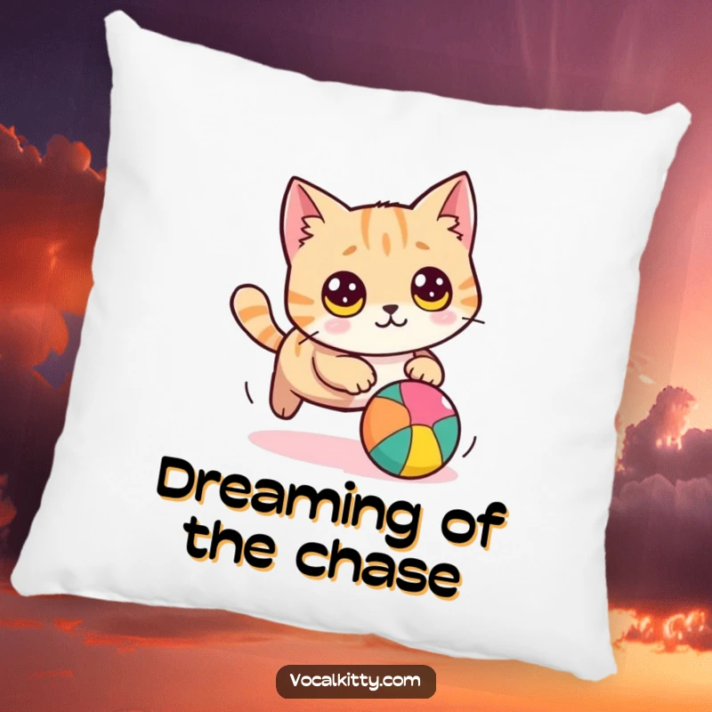 Funny cat pillow featuring a round cat with large eyes, humorously chasing a bright ball, offering comfort and a comical visual.