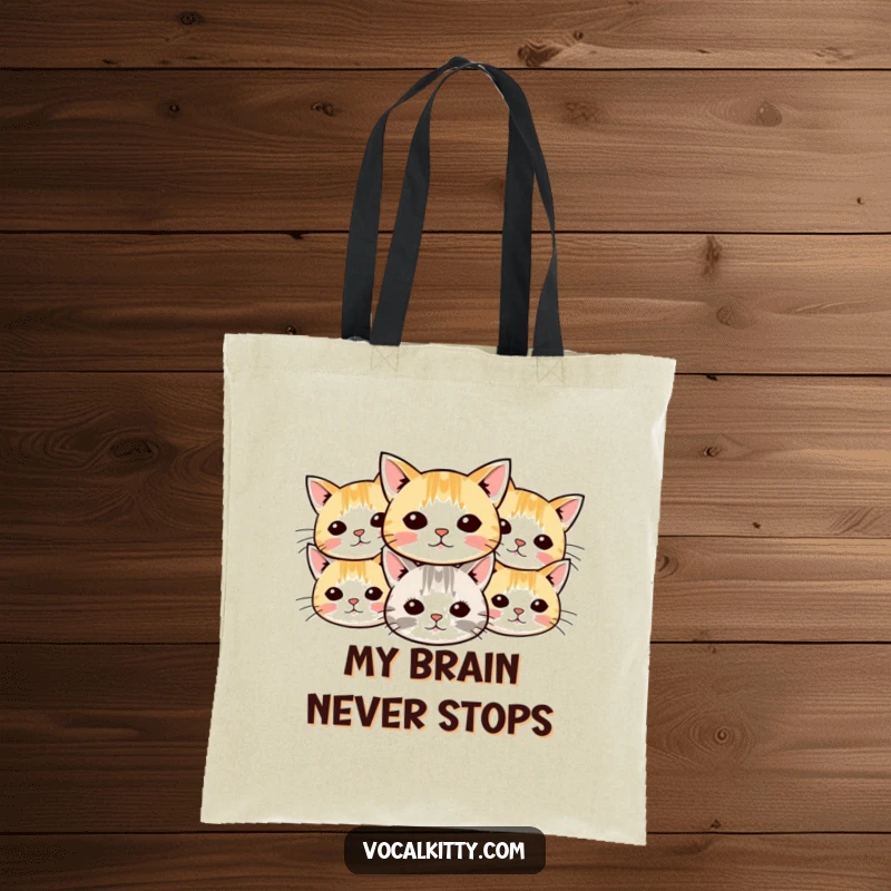 Funny cat tote bag designed with a pattern of small cartoon cat heads, their whiskers radiating outwards in a charming and humorous arrangement.