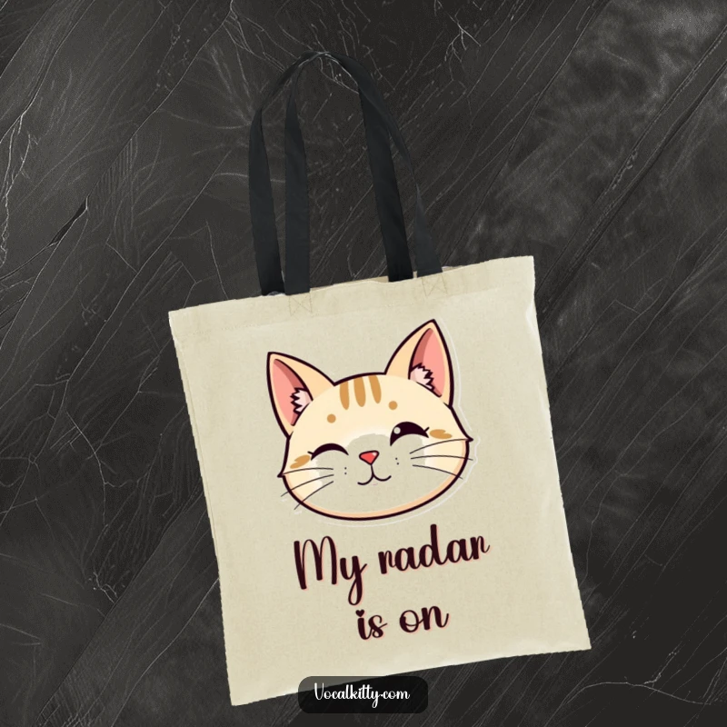 Funny tote bag: A stylized cat head with perked ears and vibrating whiskers, depicting alertness and keen interest.